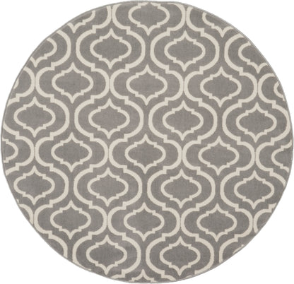 Round grey rug with white Moroccan trellis pattern; soft textile floor decor.