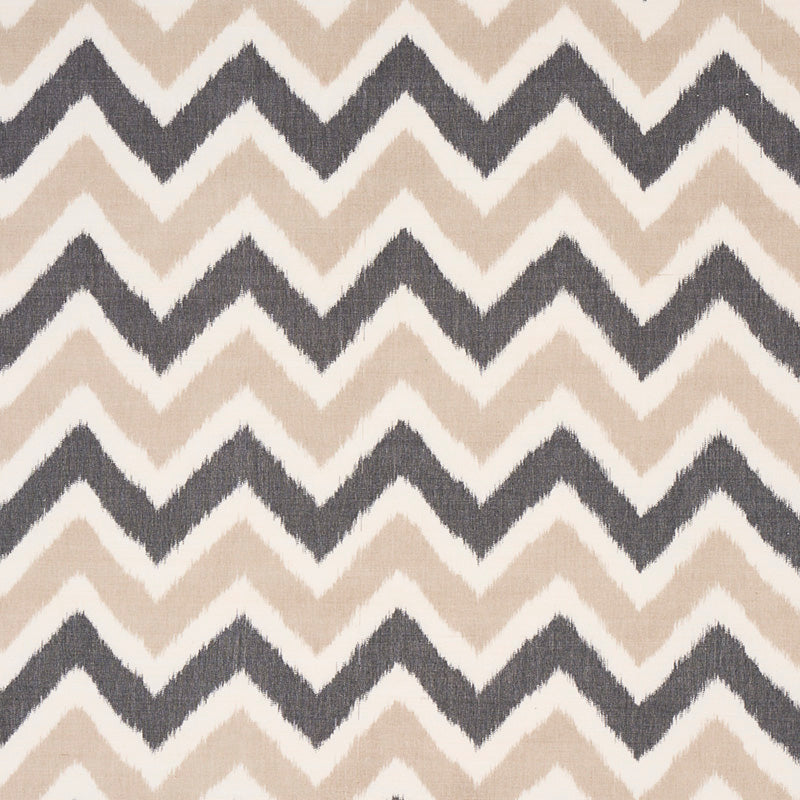 Chevron-patterned rug with alternating beige and dark gray zigzags.