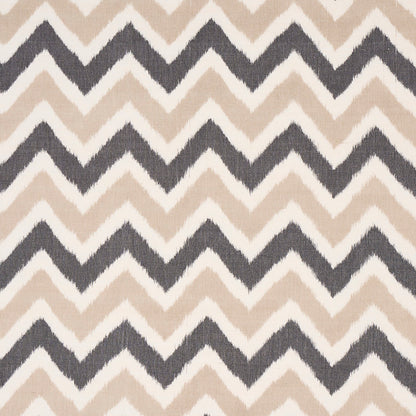 Chevron-patterned rug with alternating beige and dark gray zigzags.