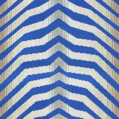 Blue and white chevron striped woven rug with beige edging; bold geometric textile.