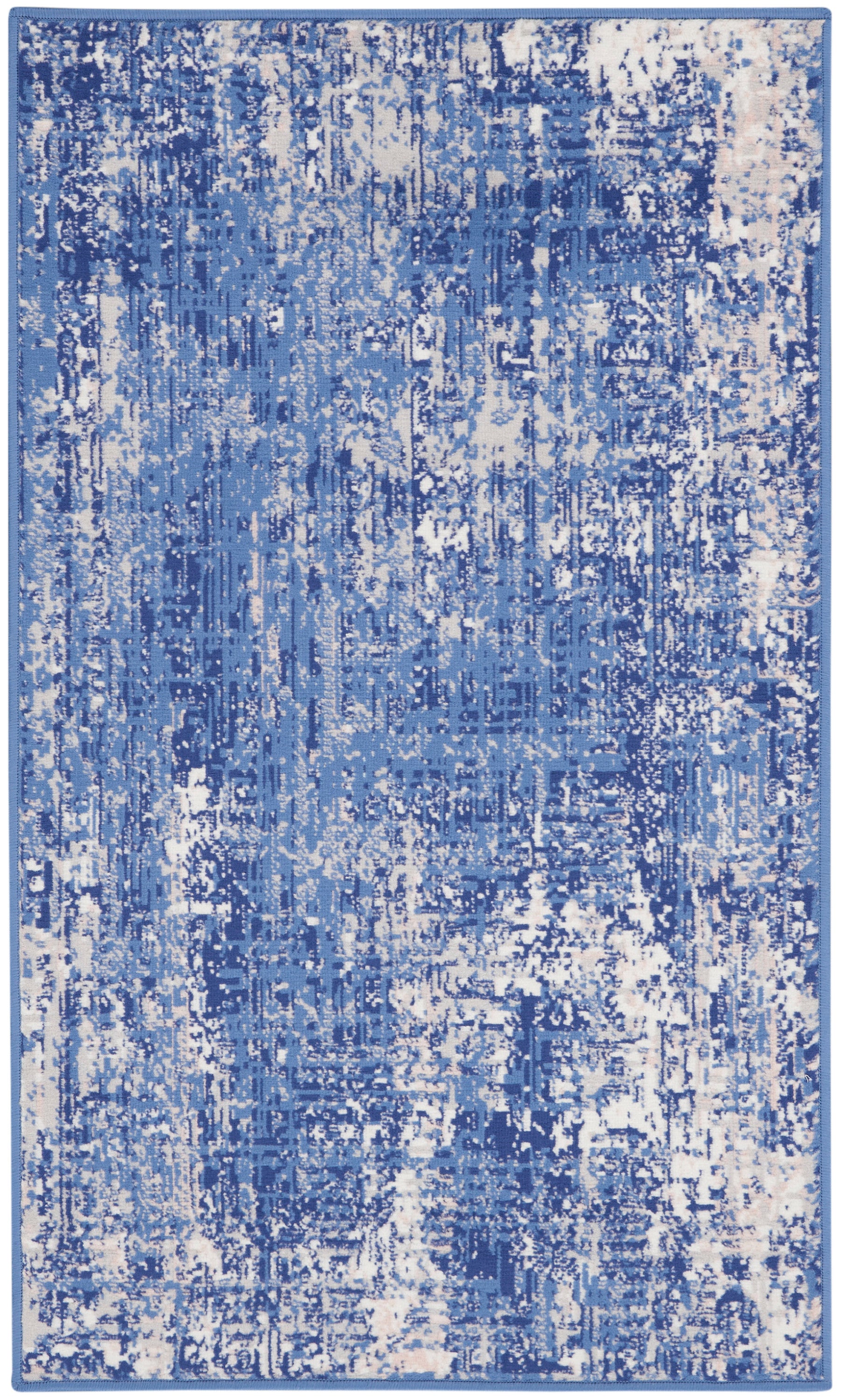 Blue distressed abstract area rug with cream specks; modern living room decor.