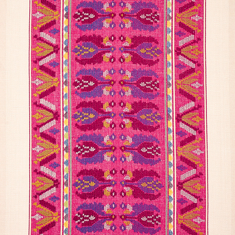 Vibrant pink kilim rug with repeating oval motifs down the center and bold geometric borders in yellow, blue, and white.