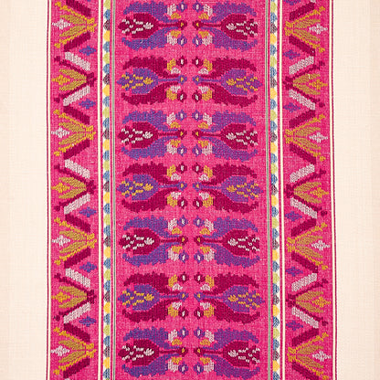 Vibrant pink kilim rug with repeating oval motifs down the center and bold geometric borders in yellow, blue, and white.
