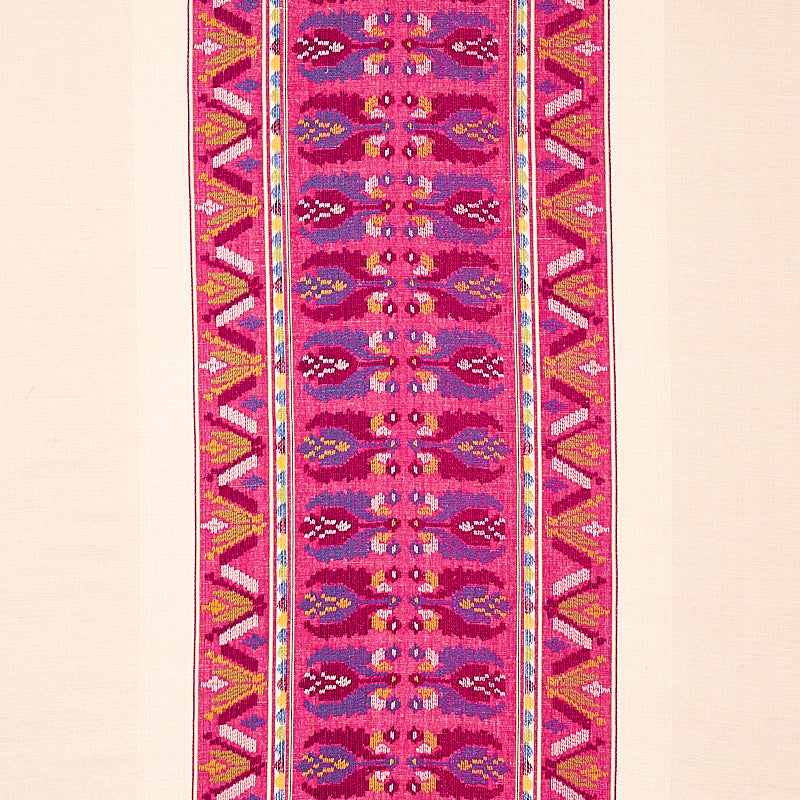Vibrant magenta woven table runner with repeating central motif and geometric yellow-blue borders.