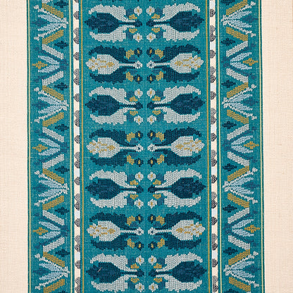 Teal woven rug runner with aqua leaf motifs, white and gold accents, and geometric borders.