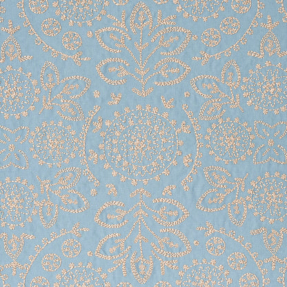 Blue fabric with ivory damask embroidery featuring floral medallions and ornamental scrolls.