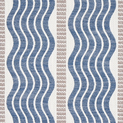 Beige area rug with navy blue wavy vertical stripes and tan dotted borders; coastal geometric textile.
