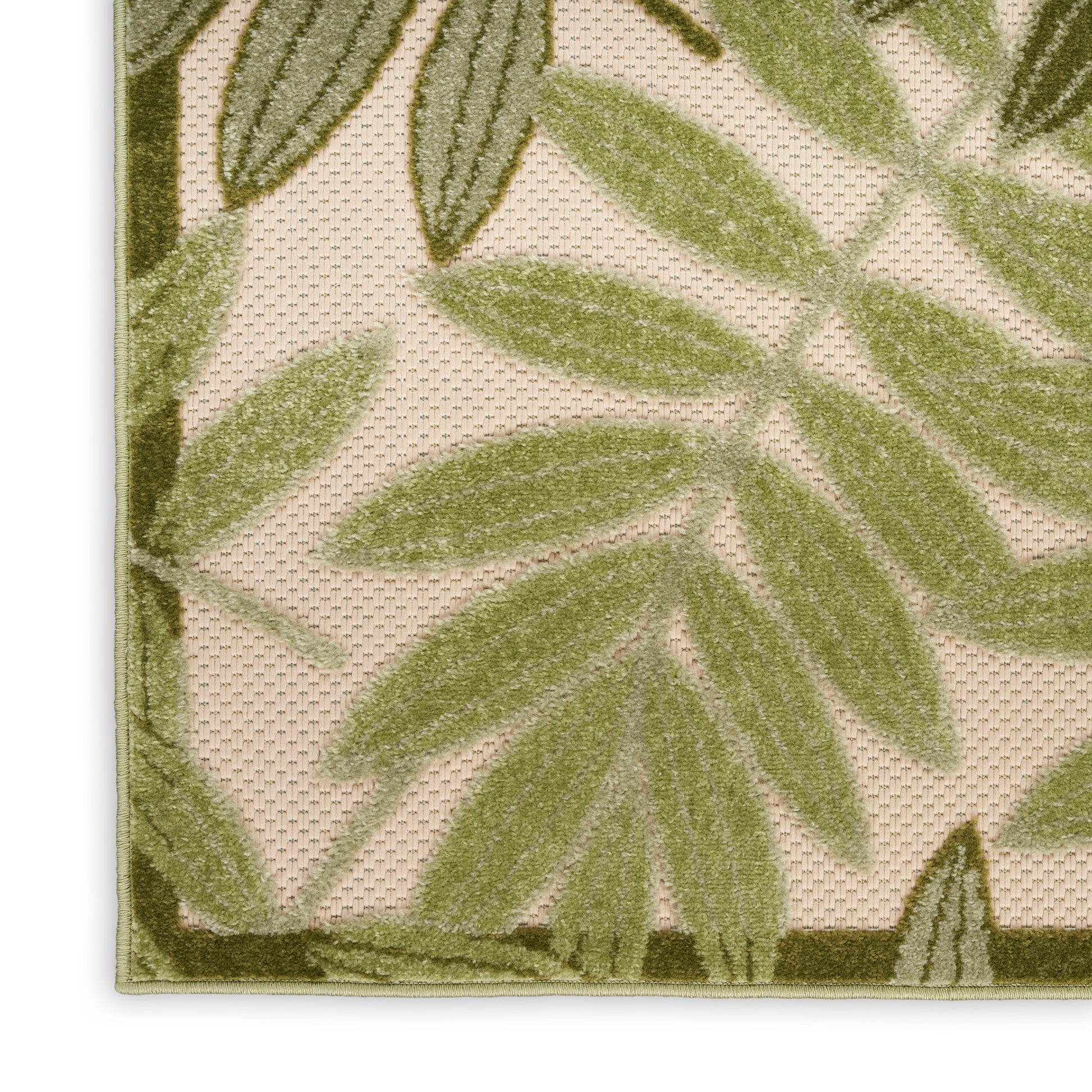 Beige textured rug with olive-green palm leaf pattern and green border.