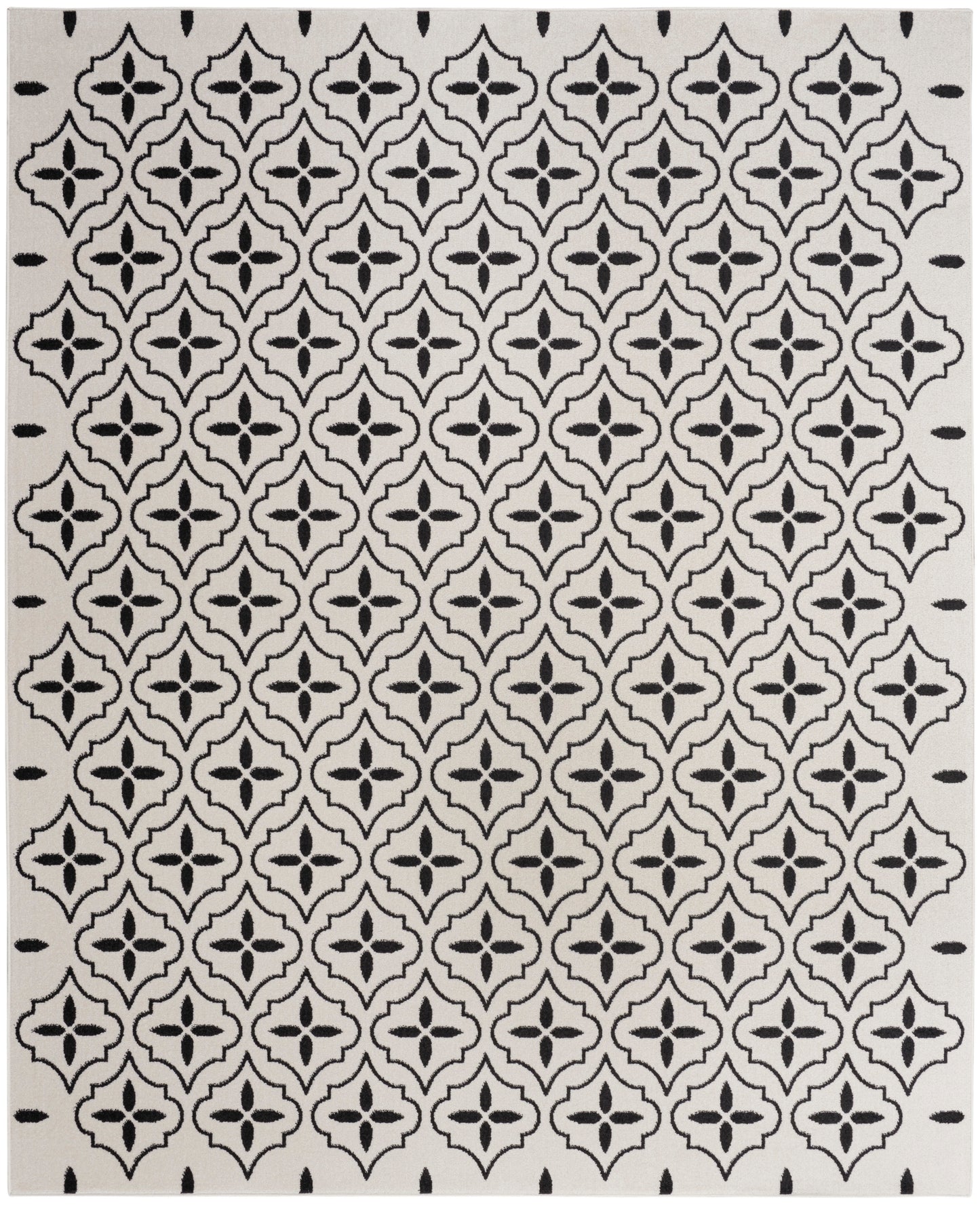 Cream rug with bold black quatrefoil lattice pattern; Moroccan-inspired geometric design for living spaces.