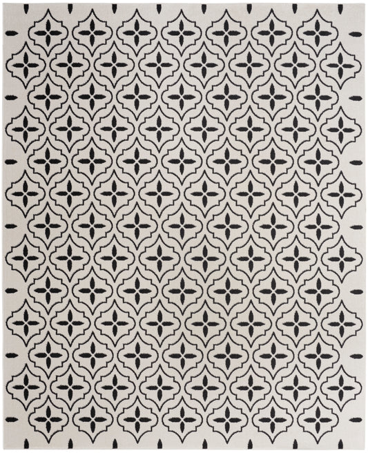 Cream rug with bold black quatrefoil lattice pattern; Moroccan-inspired geometric design for living spaces.