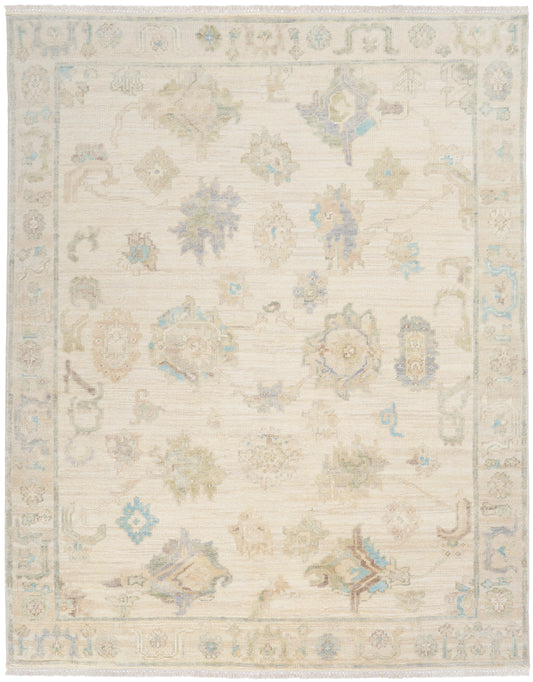Cream area rug with soft pastel florals and pale blue borders; traditional Oriental-style, fringed ends, wool-like texture.