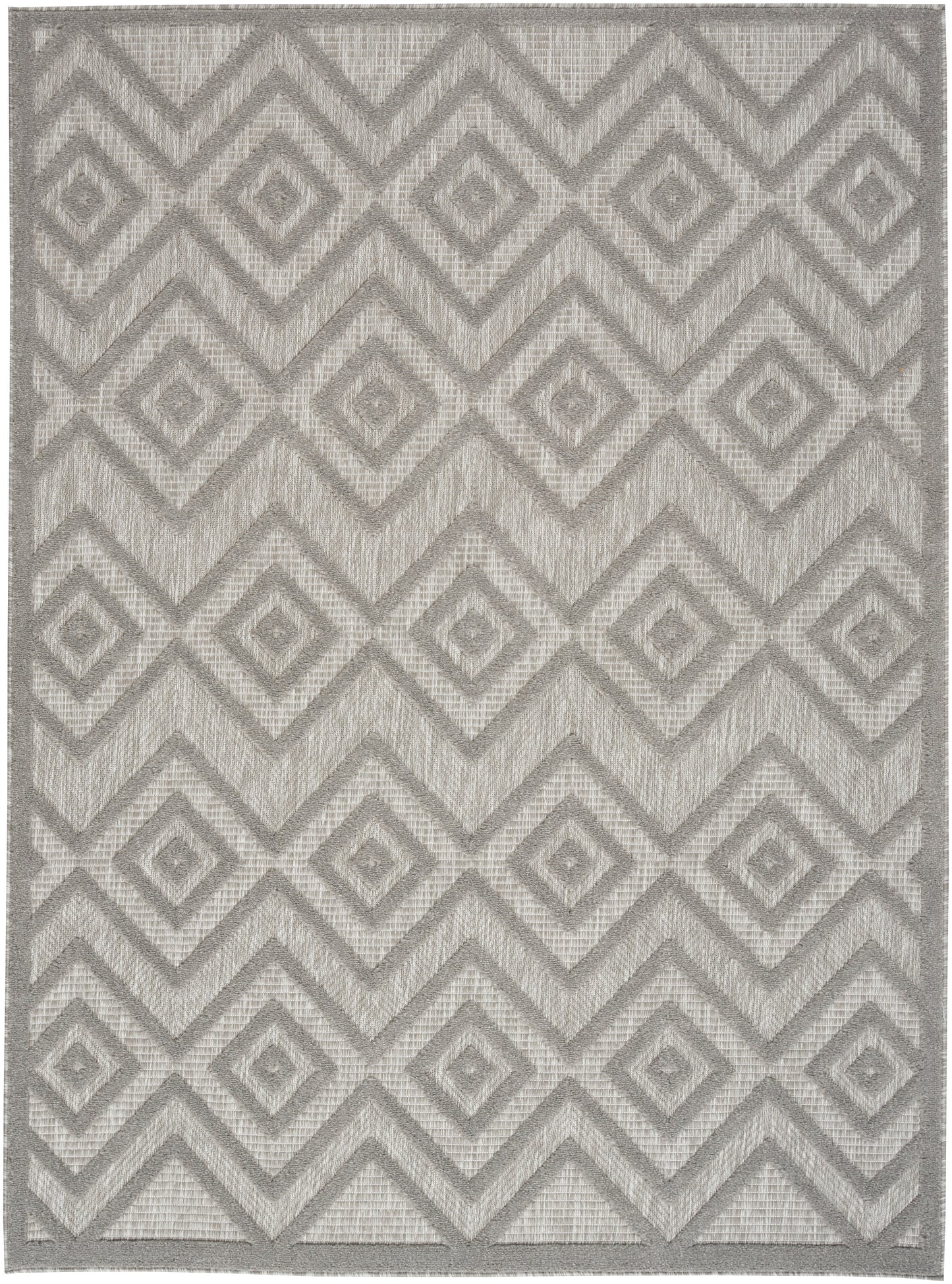 Gray geometric rug with interlocking diamond chevron pattern, woven texture, modern neutral accent.
