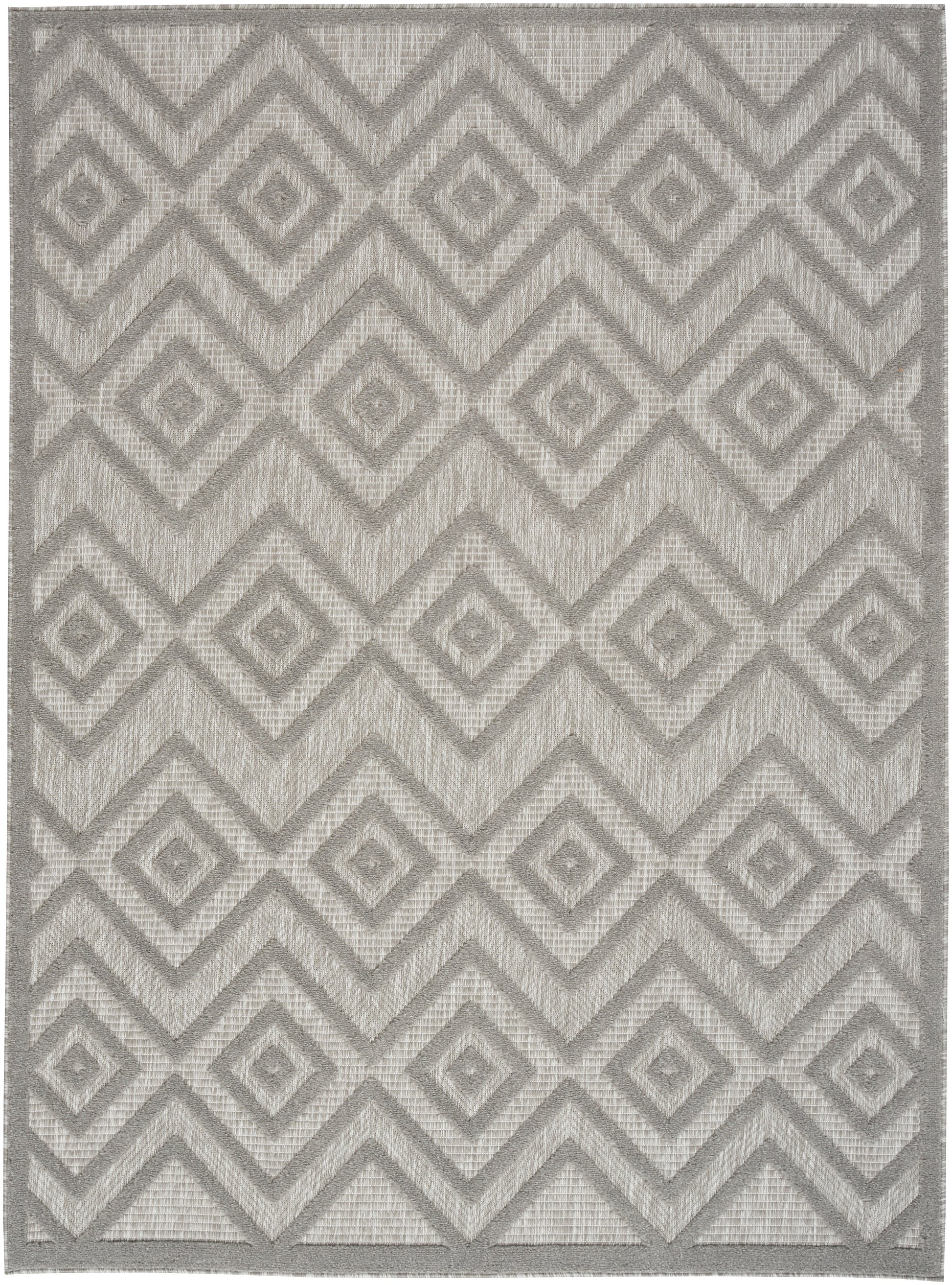 Gray geometric rug with interlocking diamond chevron pattern, woven texture, modern neutral accent.