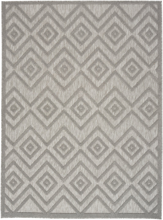Gray geometric rug with interlocking diamond chevron pattern, woven texture, modern neutral accent.
