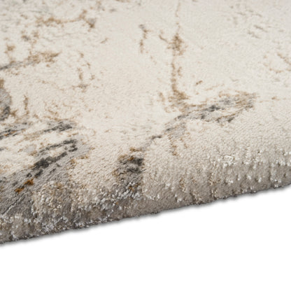 Cream beige shag rug with a light gray abstract pattern; plush pile and folded edge.