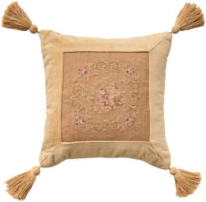 Beige square decorative pillow with burlap center floral medallion and tassels on all four corners.