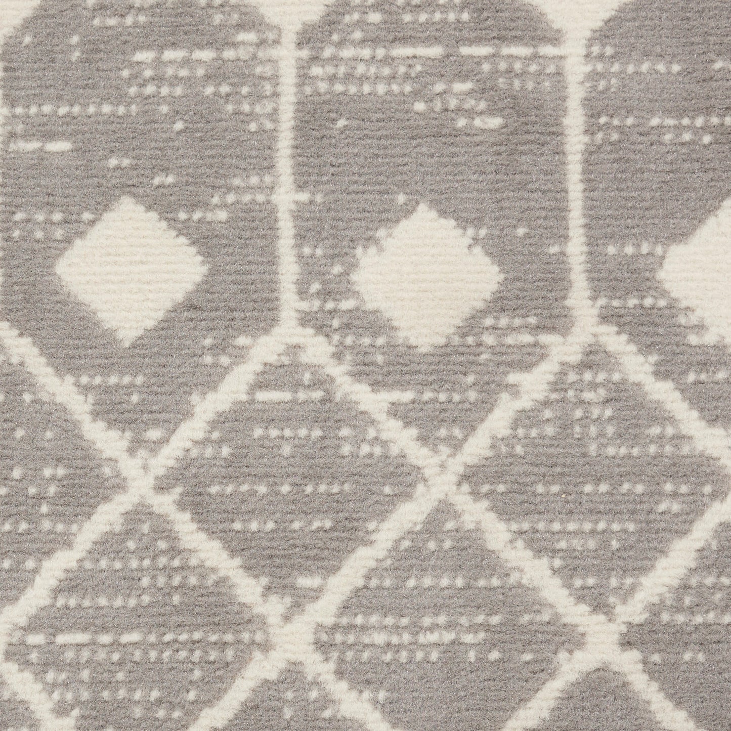 Gray and ivory woven rug featuring a repeating white diamond geometric pattern.