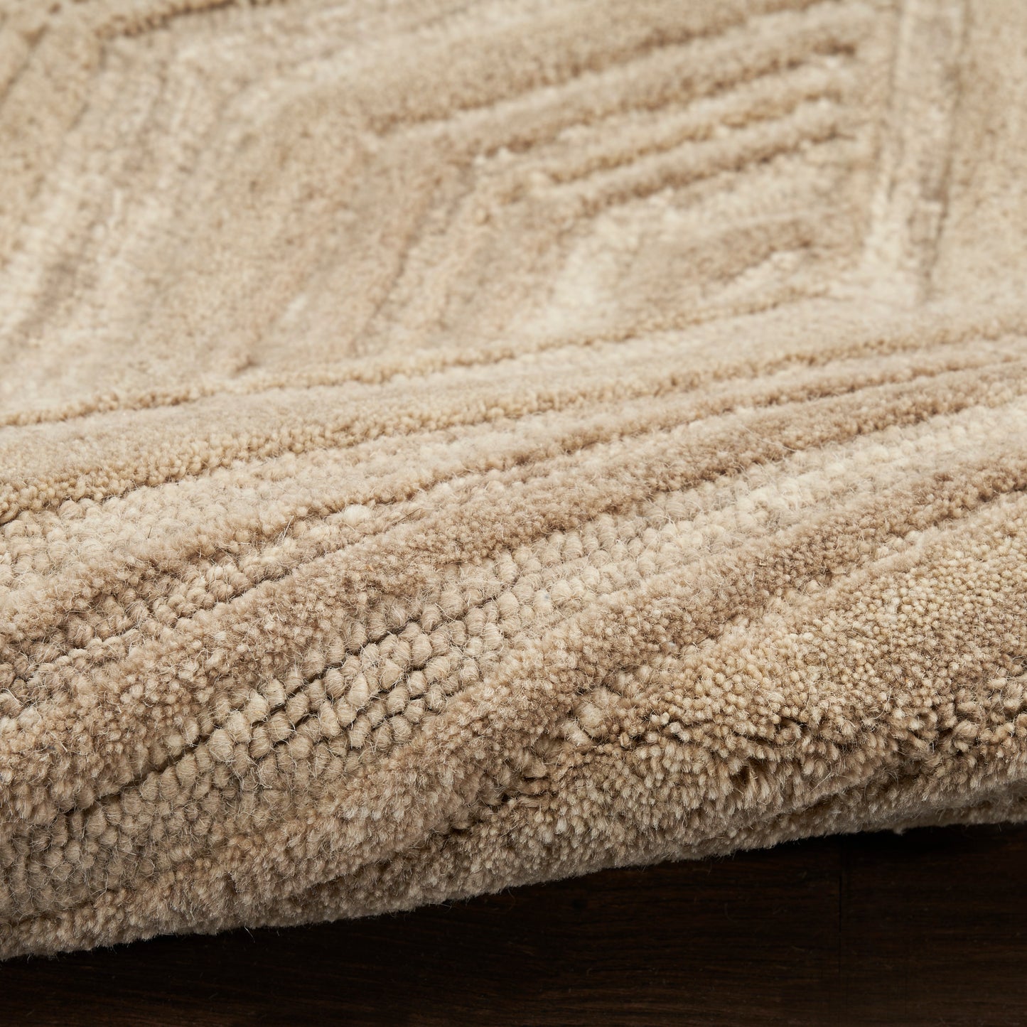 Beige plush shag rug with thick, textured pile and subtle geometric lines for a cozy floor covering.