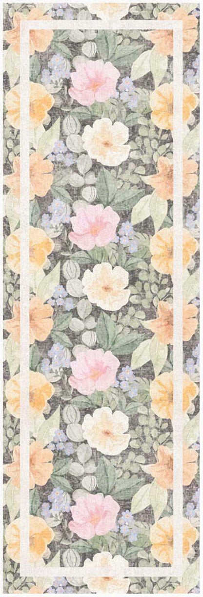 Floral print on a gray runner rug with peach and pink blossoms and green leaves; cream and peach border.
