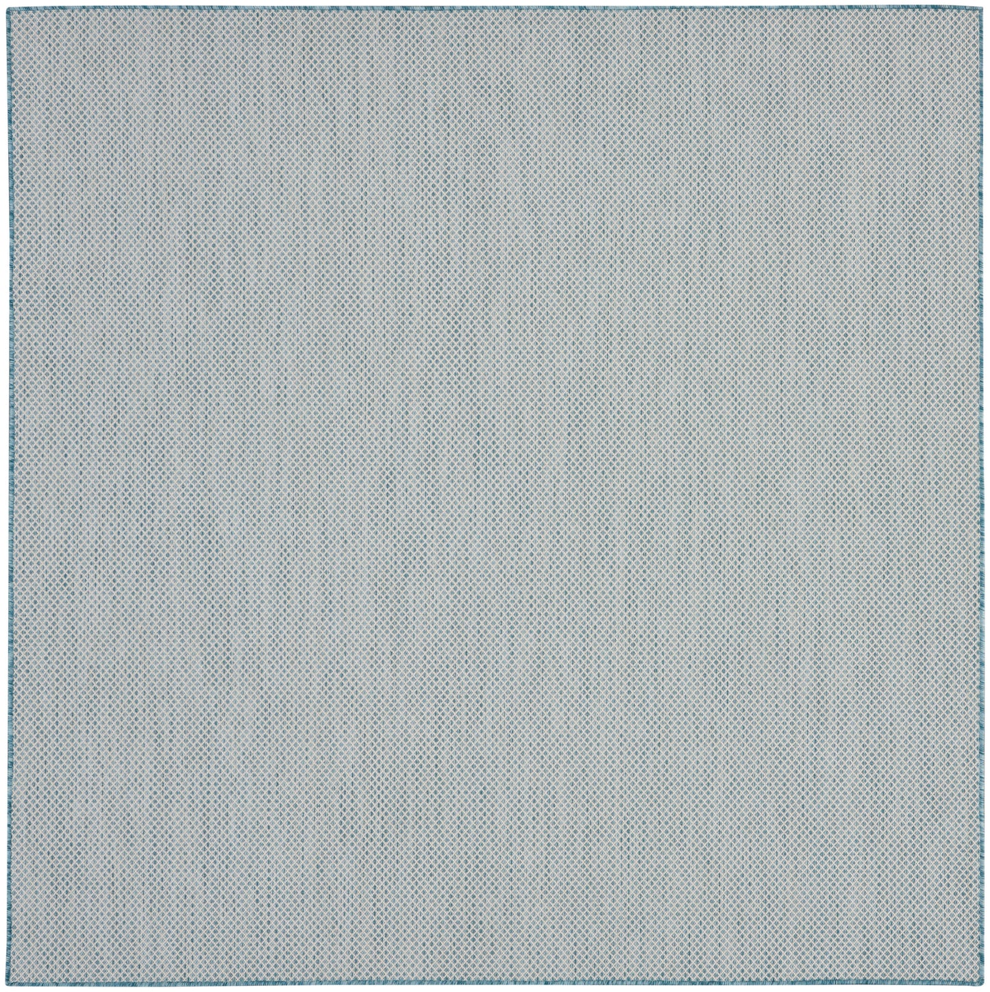 Light gray-blue rug with a tiny blue dot pattern and a stitched border.
