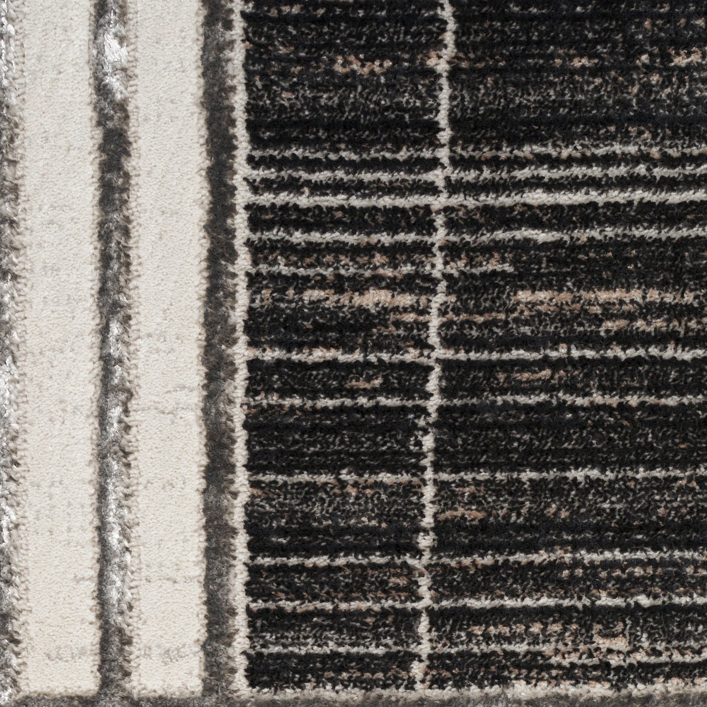 Beige-bordered rug with dark charcoal stripes; plush textured pile in a modern geometric pattern.