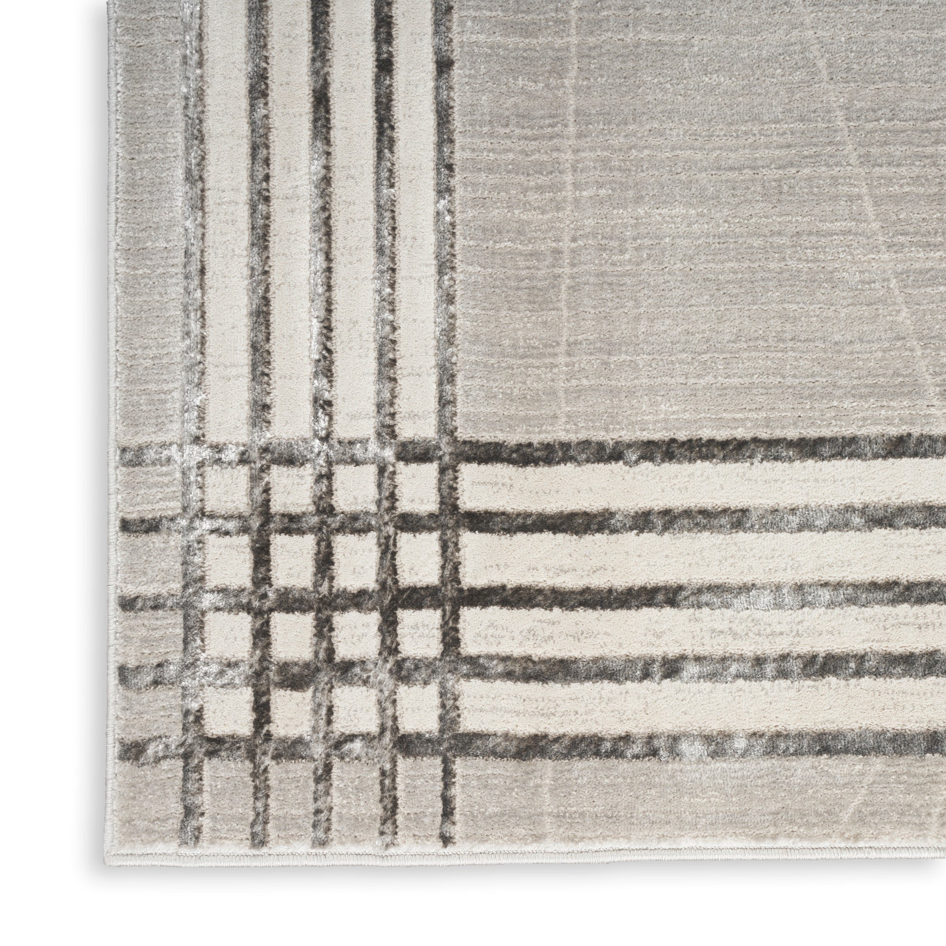 Beige textured rug with charcoal plaid grid pattern in corner; modern & abstract lines, soft pile.