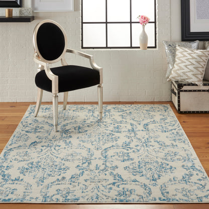 Blue floral area rug in a bright living room, 4' x 6'.