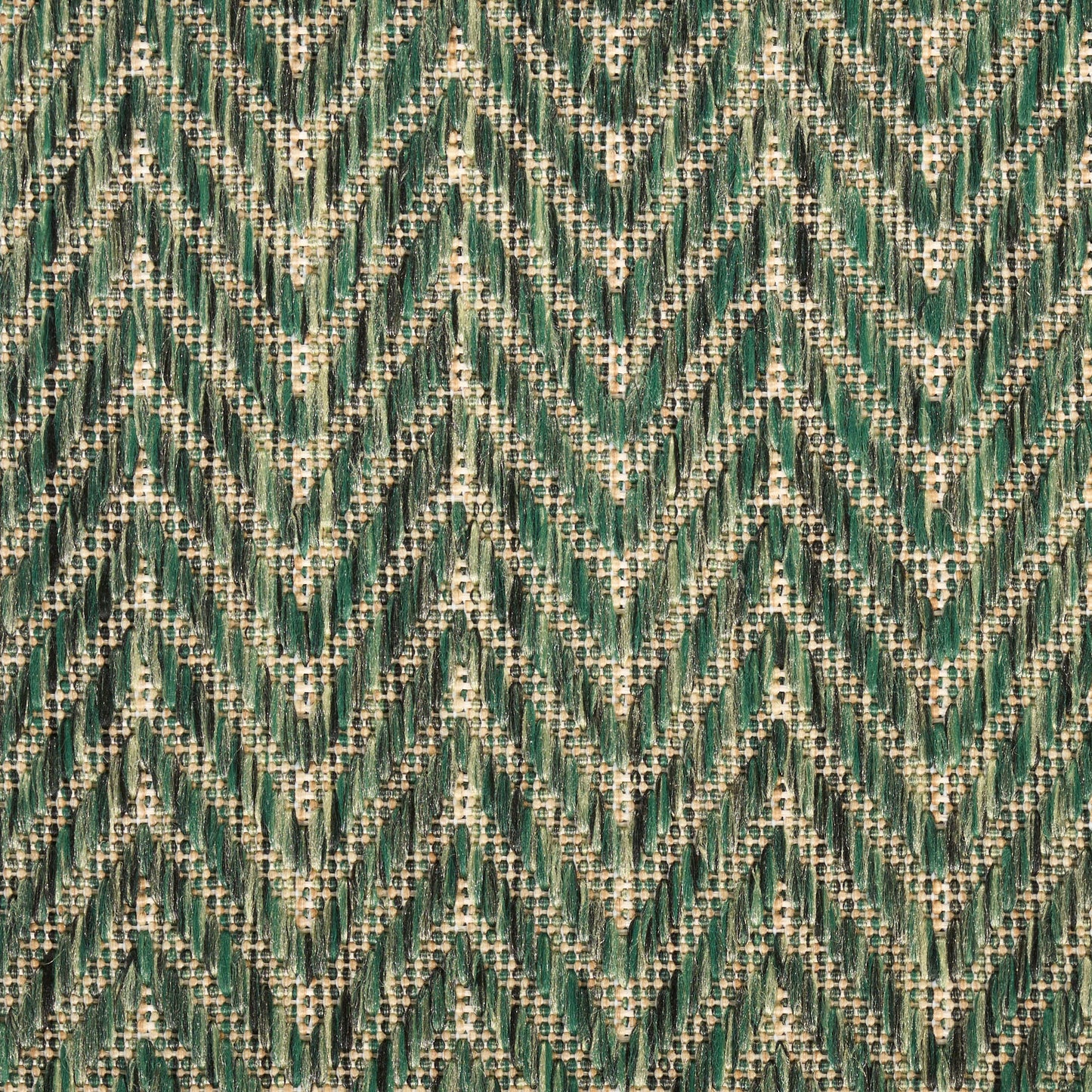 Green chevron zigzag woven fabric with cream specks; emerald and teal tones for upholstery or clothing.