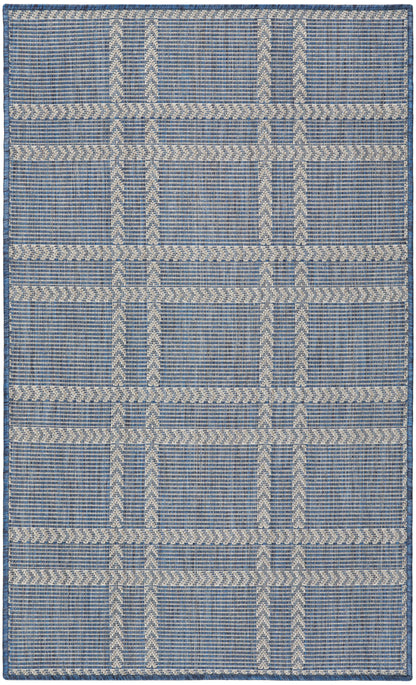 Blue and ivory woven flat-weave rug with geometric grid and chevron stripes; rectangular, casual living room or entryway.