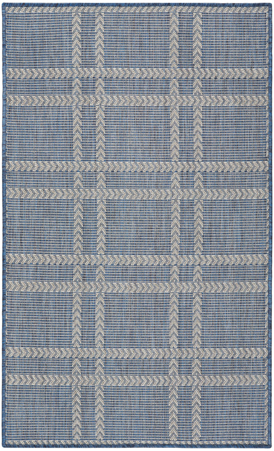 Blue and ivory woven flat-weave rug with geometric grid and chevron stripes; rectangular, casual living room or entryway.