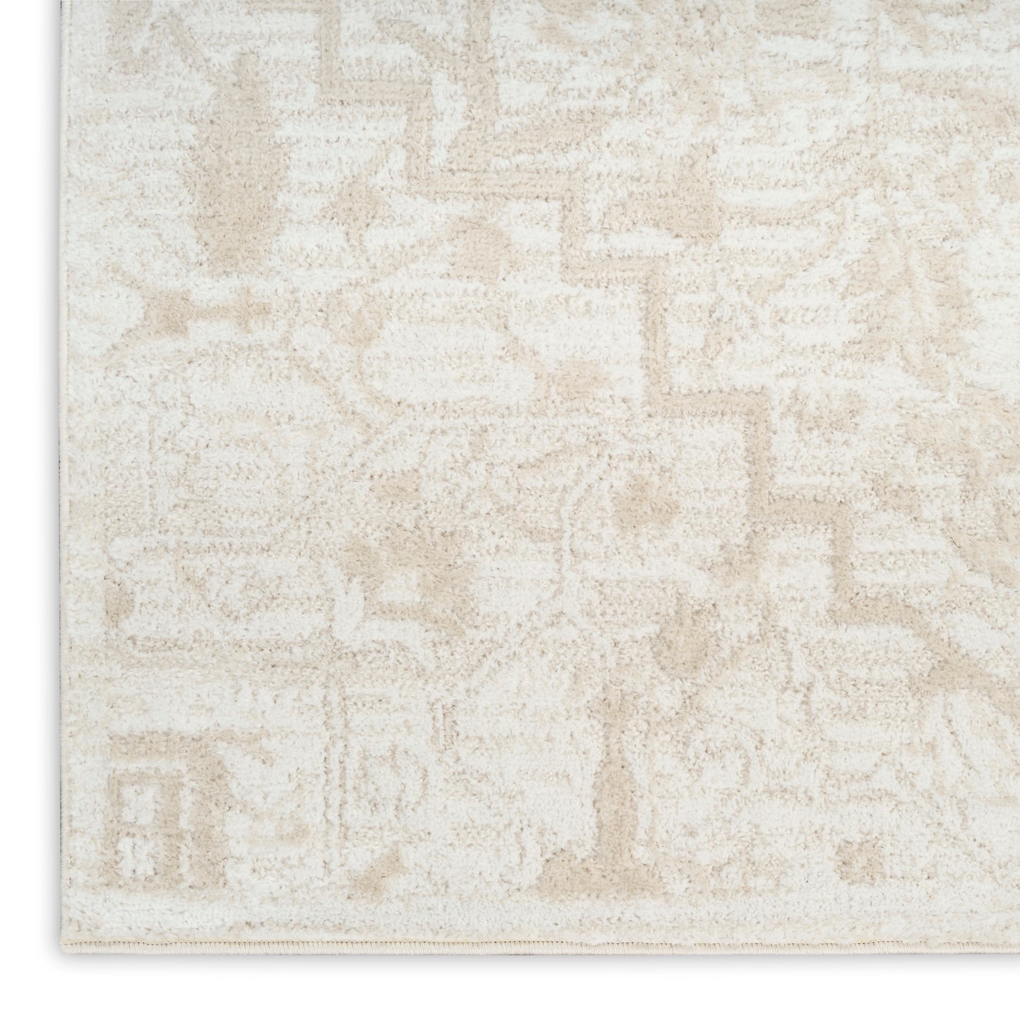 Cream area rug with a soft beige geometric pattern and plush textured pile.