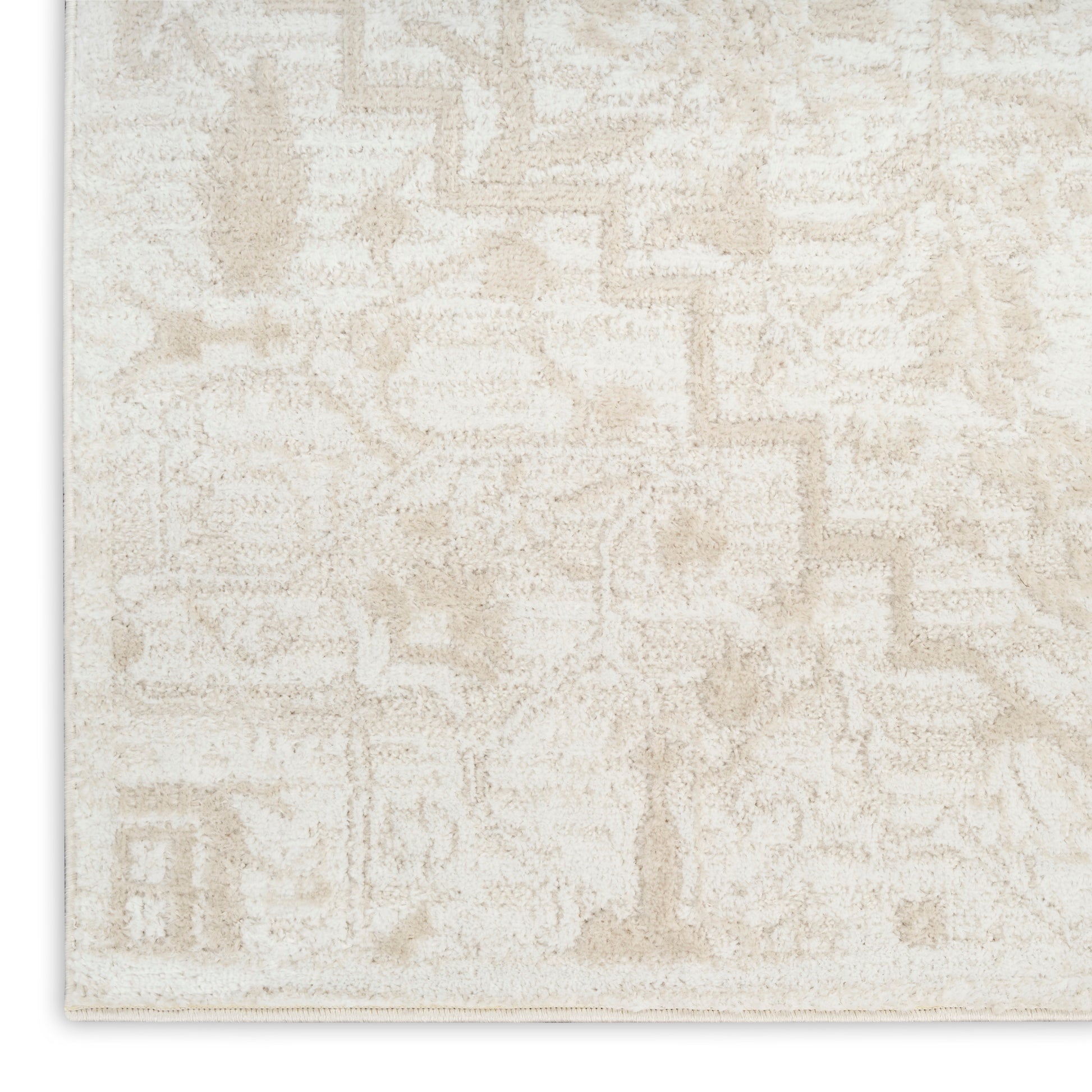 Cream area rug with a soft beige geometric pattern and plush textured pile.