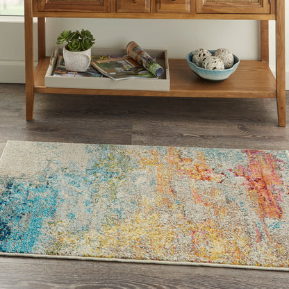 Abstract multicolor area rug with beige base; blue, yellow, orange, pink splashes add modern warmth to living room.
