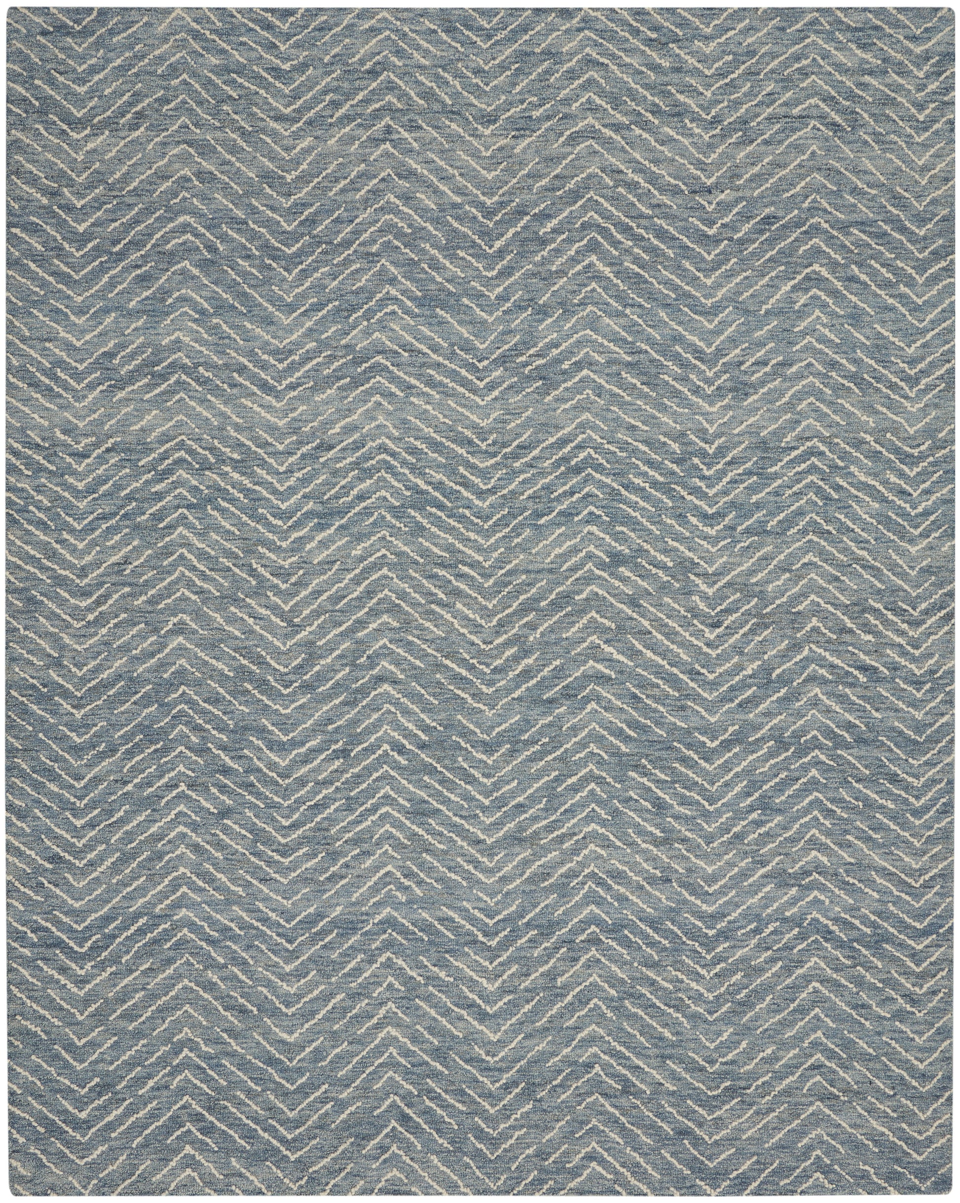 Blue-gray rug with ivory chevron zigzag pattern and soft woven texture; modern geometric decor.