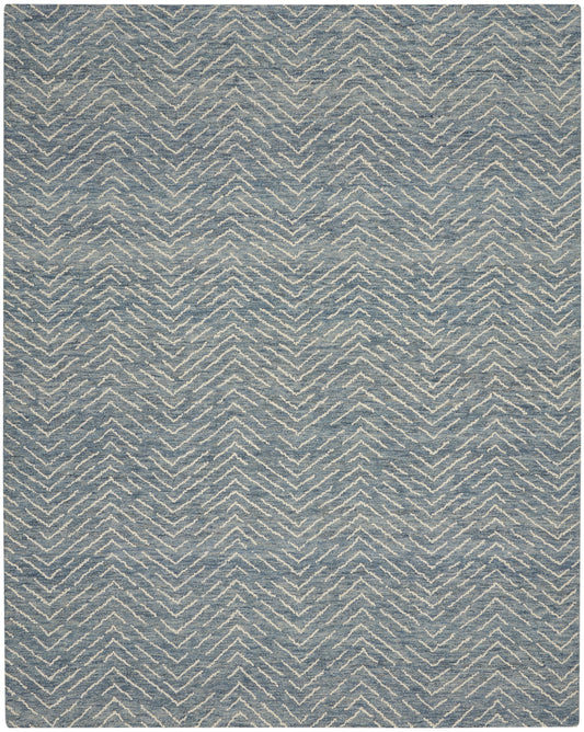 Blue-gray rug with ivory chevron zigzag pattern and soft woven texture; modern geometric decor.