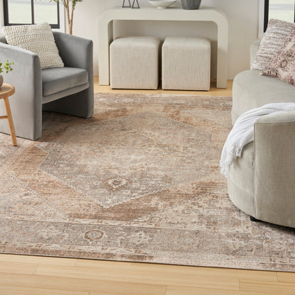 Neutral living room with beige rug, gray fabric armchair, beige sofa, cream curved console, and two cream ottomans.