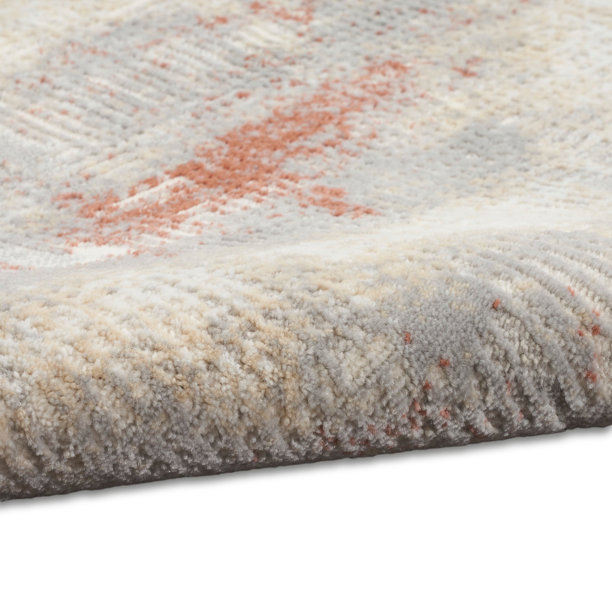 Soft plush area rug in cream, beige and gray with subtle orange accents; abstract pattern and thick pile.
