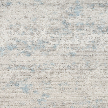 Cream shag rug with pale blue abstract patches; plush textured rectangular area rug for living room or bedroom.