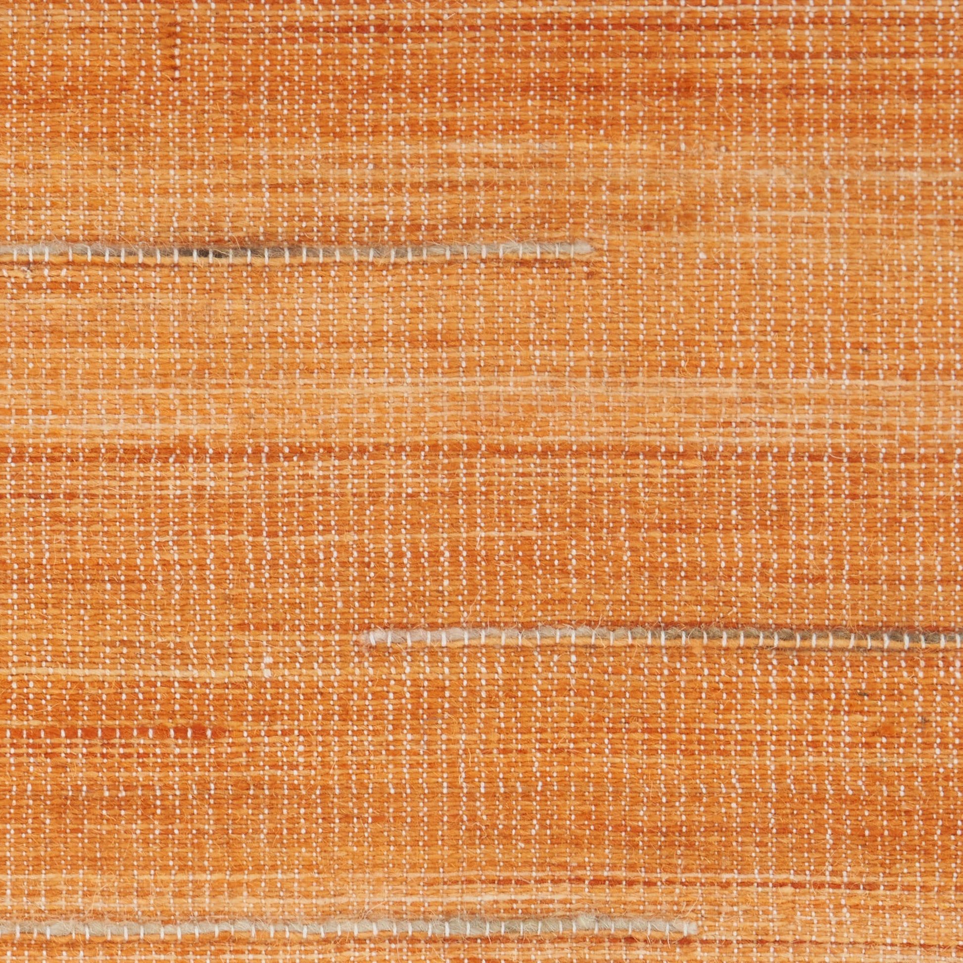 Orange woven rug with cream horizontal stripes and grid texture, 5' x 7'.