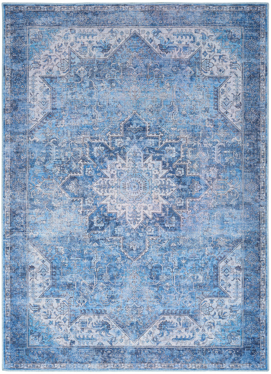 Blue distressed Persian-style area rug with central medallion, ornate border, and delicate floral motifs.
