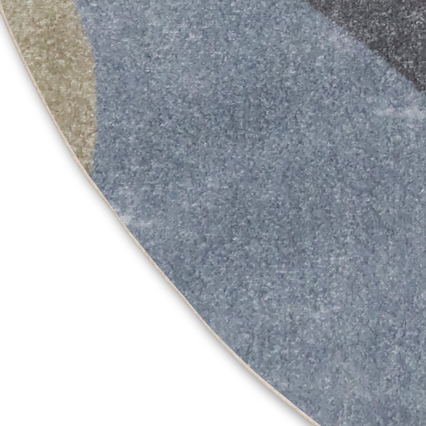 Partial view of a round rug with blue-gray speckled pattern & beige border.