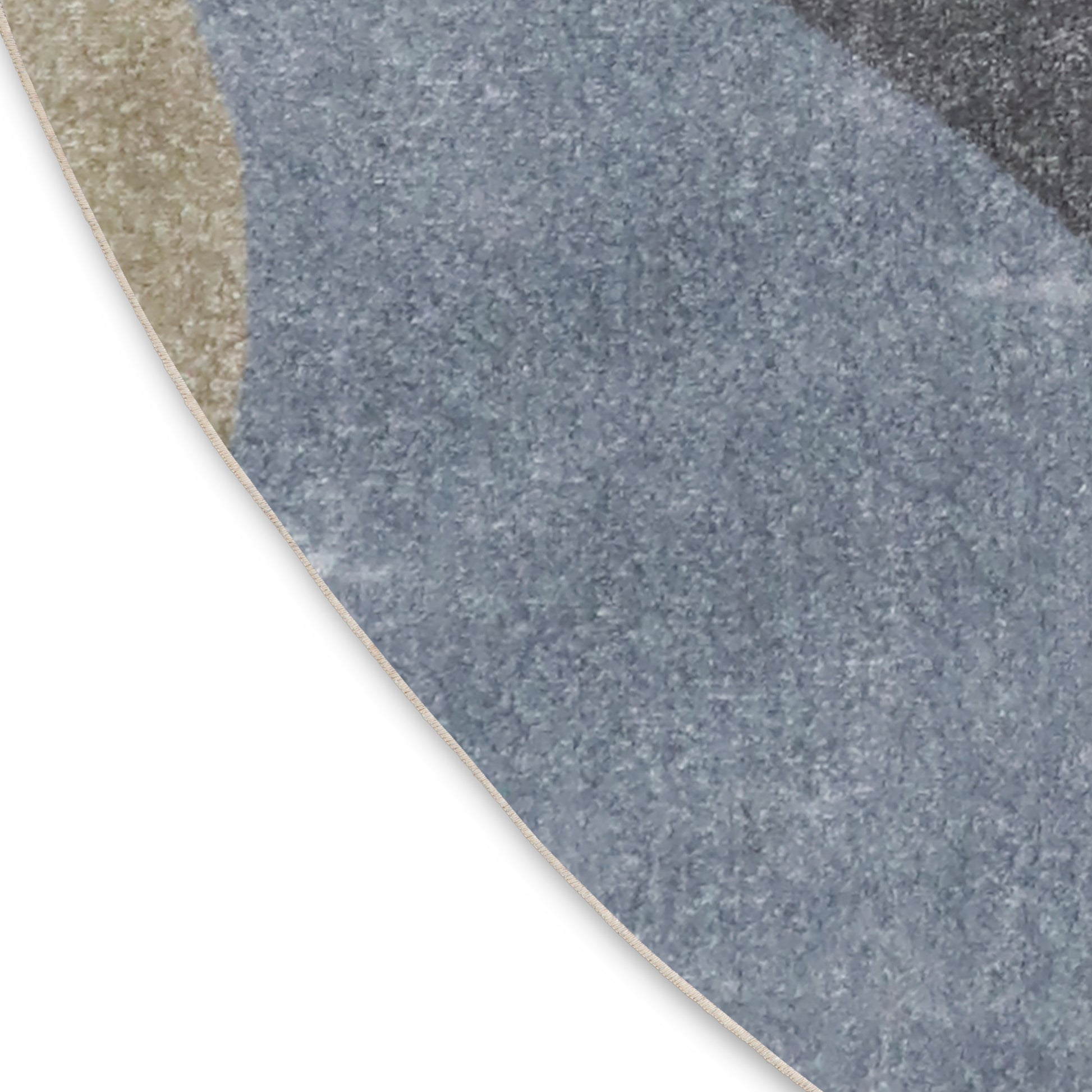 Partial view of a round rug with blue-gray speckled pattern & beige border.