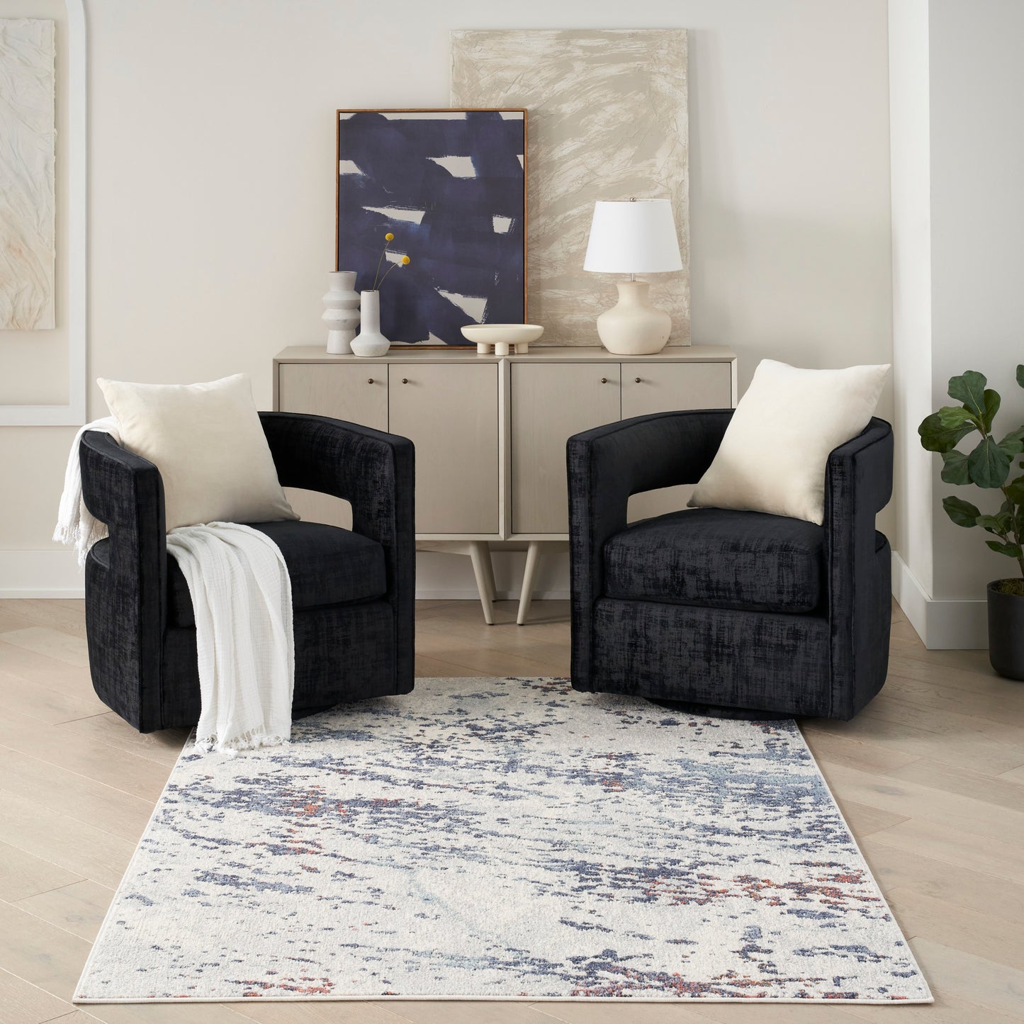 Blue-gray patterned rug (5' x 7') in a room with a beige console and abstract art.