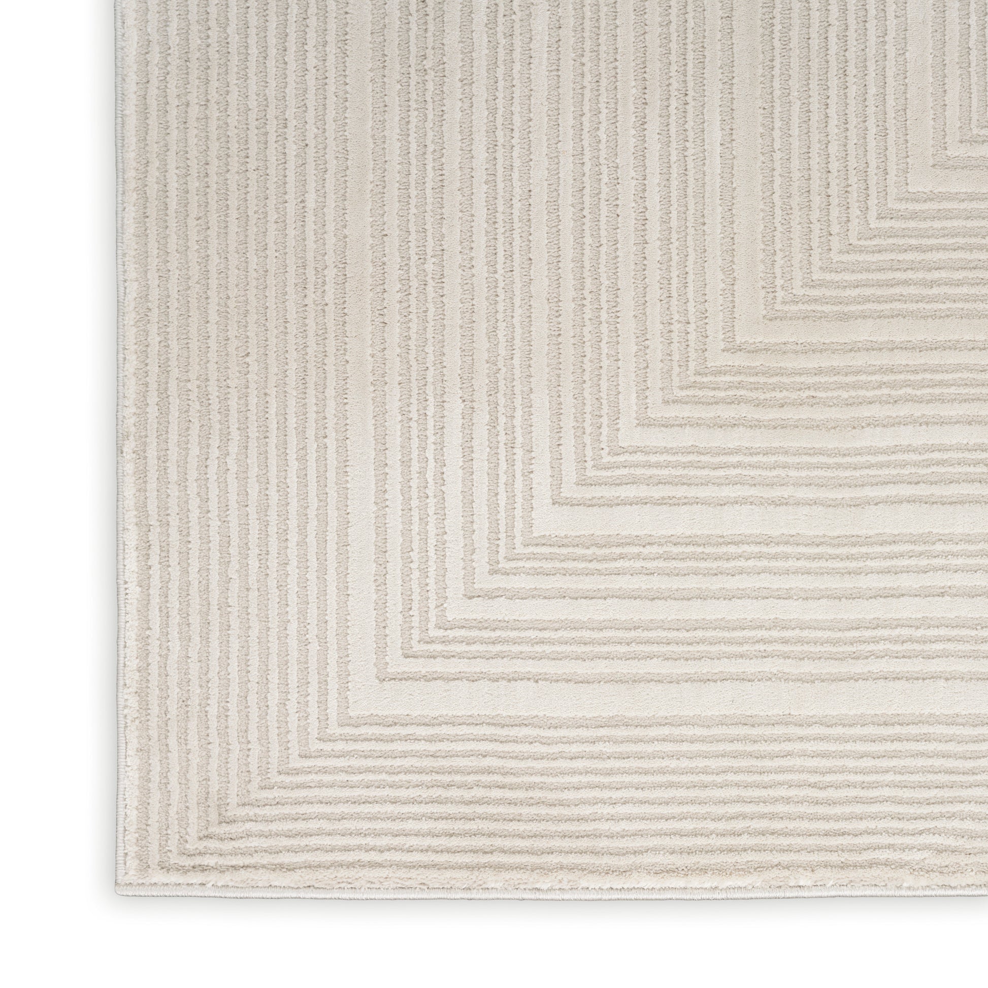 Beige woven rug with cream geometric concentric square border pattern; textured, neutral decor.