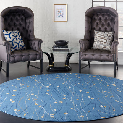 Blue patterned round rug (8' diameter) under two dark brown tufted leather armchairs with nailhead trim and a glass round coffee table.