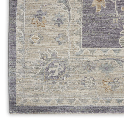 Partial view of a vintage-inspired rug: cream/beige base, blue border and accents, purple inner field with floral motifs.