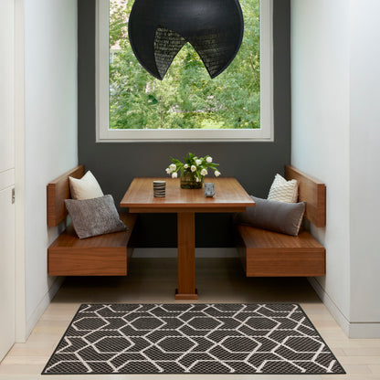 Modern geometric rug on the floor in a room setting (3' x 5').