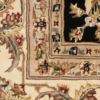 Ornate Persian-style rug fragment with beige field, black inner panel, and red-green floral border.