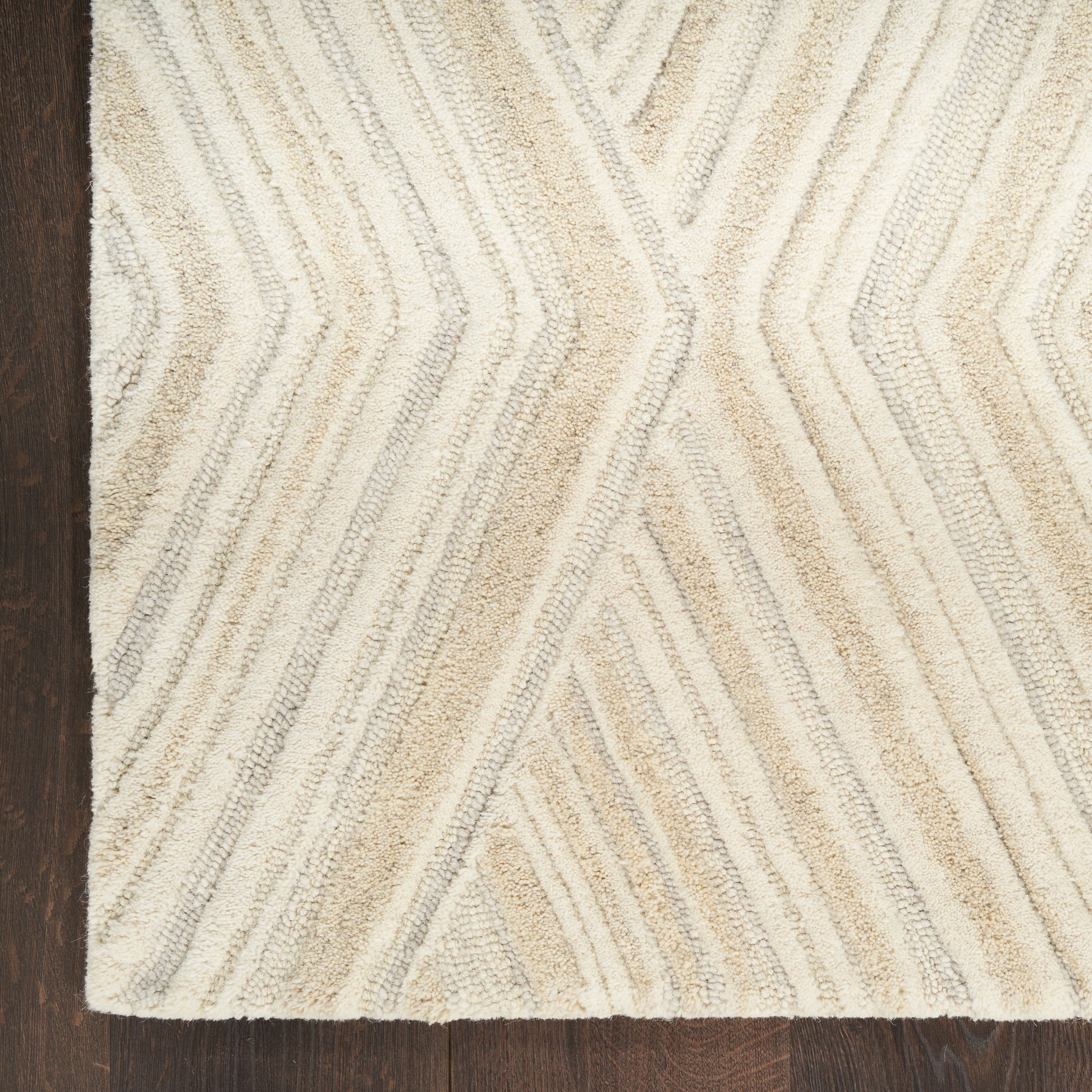 Beige & cream chevron-patterned shag rug with soft pile on dark wooden floor.