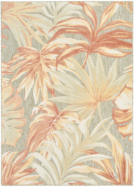 Tropical palm leaf rug in peach, cream, and beige tones on a gray textured backdrop; large botanical pattern.